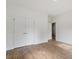 Bedroom features wood grain floors and a closet with double doors at 1408 South St, Durham, NC 27707