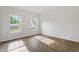 Bedroom has wood grain floors and bright windows overlooking the side of the property at 1408 South St, Durham, NC 27707