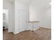 Hallway landing features wood grain floors, a bright white door, and stairs with white banisters at 1408 South St, Durham, NC 27707