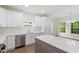 Bright kitchen features stainless steel appliances, white quartz counters, and a gray island with bar seating at 1408 South St, Durham, NC 27707