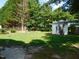 Large backyard with a storage shed and chain link fence at 204 Southland Dr, Zebulon, NC 27597