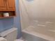 Full bathroom features a wooden cabinet, toilet and shower-tub combo at 204 Southland Dr, Zebulon, NC 27597