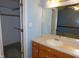 Bright bathroom with white sink, vanity, and a view into the closet at 204 Southland Dr, Zebulon, NC 27597