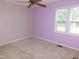 Comfortable bedroom features a ceiling fan, natural light, neutral carpet and painted walls at 204 Southland Dr, Zebulon, NC 27597