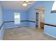 Spacious bedroom with blue walls, ceiling fan and en suite bathroom at 204 Southland Dr, Zebulon, NC 27597