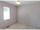 Bright bedroom with a ceiling fan, window and patterned wallpapered walls at 204 Southland Dr, Zebulon, NC 27597