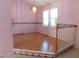Dining room with chandelier, light pink walls and view to living room at 204 Southland Dr, Zebulon, NC 27597