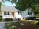 Charming white house with black shutters, front porch, and well-maintained landscaping at 204 Southland Dr, Zebulon, NC 27597