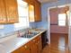 Kitchen featuring stainless steel sink, wooden cabinets, and great natural light at 204 Southland Dr, Zebulon, NC 27597