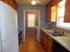Kitchen with wooden cabinets, white appliances and a view to laundry room at 204 Southland Dr, Zebulon, NC 27597