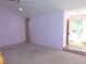 Large living room with pink walls and a door leading outside at 204 Southland Dr, Zebulon, NC 27597