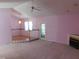 Cozy living room with light pink walls, fireplace, ceiling fan and light fixture at 204 Southland Dr, Zebulon, NC 27597
