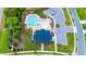 Aerial view of a community pool and neighborhood with mature trees and landscaping at 300 Ledge Manor Dr, Holly Springs, NC 27540