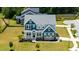Overhead shot of a beautiful home, highlighting its manicured lawn and appealing neighborhood setting at 300 Ledge Manor Dr, Holly Springs, NC 27540