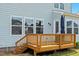 Wooden back deck with railings, access to yard, and beautiful outdoor seating at 300 Ledge Manor Dr, Holly Springs, NC 27540