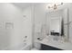 Bathroom featuring a tiled shower/tub combo, quartz counters, and undermount sink at 300 Ledge Manor Dr, Holly Springs, NC 27540