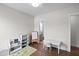 Spacious bedroom featuring hardwood floors, bookcase, and an adjacent bathroom at 300 Ledge Manor Dr, Holly Springs, NC 27540