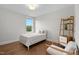 Bright bedroom with hardwood floors, a twin bed and a reading nook at 300 Ledge Manor Dr, Holly Springs, NC 27540