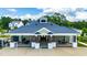 Rear view of clubhouse with outdoor seating and covered patio at 300 Ledge Manor Dr, Holly Springs, NC 27540