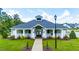 Community clubhouse featuring manicured lawn, and stately entrance at 300 Ledge Manor Dr, Holly Springs, NC 27540