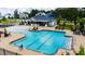 Community pool area features zero entry splash area, sun loungers and chairs for residents at 300 Ledge Manor Dr, Holly Springs, NC 27540