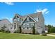 Side view of the home showcasing its architectural design, well-maintained lawn, and attached garage at 300 Ledge Manor Dr, Holly Springs, NC 27540