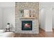 Close-up of the stone fireplace with a raised hearth and decorative mantel at 300 Ledge Manor Dr, Holly Springs, NC 27540