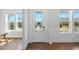 Bright foyer features a white front door with glass and sidelight windows and hardwood floors at 300 Ledge Manor Dr, Holly Springs, NC 27540