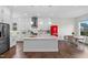 Modern kitchen with large island, stainless appliances, and open floorplan design at 300 Ledge Manor Dr, Holly Springs, NC 27540