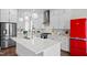 Modern kitchen features a large island, stainless appliances, and retro red refrigerator at 300 Ledge Manor Dr, Holly Springs, NC 27540