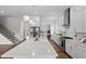 Bright kitchen boasts white cabinets, stainless appliances, and a large center island at 300 Ledge Manor Dr, Holly Springs, NC 27540