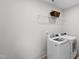 Neat laundry room with modern washer, dryer, and wire shelving at 300 Ledge Manor Dr, Holly Springs, NC 27540