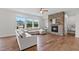 Comfortable living room showcasing a stone fireplace, hardwood flooring, and a plush sectional sofa at 300 Ledge Manor Dr, Holly Springs, NC 27540
