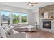 Bright living space with a stone fireplace, hardwood floors, and a large sectional sofa perfect for relaxing at 300 Ledge Manor Dr, Holly Springs, NC 27540