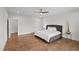 Spacious main bedroom features hardwood floors, ceiling fan, and a comfortable bed at 300 Ledge Manor Dr, Holly Springs, NC 27540