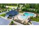Inviting community pool and lounge area with mature trees and landscaping at 300 Ledge Manor Dr, Holly Springs, NC 27540