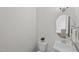 Classic powder room features a pedestal sink, round mirror, and decorative accents at 300 Ledge Manor Dr, Holly Springs, NC 27540