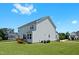 Rear exterior of a home with a small wooden deck, light blue siding, and a lush green lawn at 300 Ledge Manor Dr, Holly Springs, NC 27540
