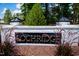Community sign with white brick and black trim featuring bronze lettering at 300 Ledge Manor Dr, Holly Springs, NC 27540