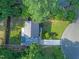 Aerial view of a meticulously maintained home, lush landscaping, and a private backyard oasis surrounded by mature trees at 4 Galaxy Ct, Durham, NC 27705