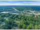Aerial view showcasing a neighborhood's convenient location near shopping centers and major highways, surrounded by lush greenery at 4 Galaxy Ct, Durham, NC 27705