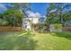Spacious backyard with well-maintained lawn, wood fence, patio seating, and mature trees at 4 Galaxy Ct, Durham, NC 27705