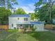 Spacious fenced backyard includes grass, patio with seating, and mature trees at 4 Galaxy Ct, Durham, NC 27705