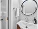 Stylish half-bathroom with circular mirror, decorative faucet and a white towel at 4 Galaxy Ct, Durham, NC 27705