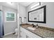 Bathroom features granite countertops, undermount sink, and window letting in natural light at 4 Galaxy Ct, Durham, NC 27705