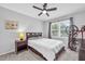 Cozy bedroom with a comfortable bed, gray curtains, large window, and a ceiling fan at 4 Galaxy Ct, Durham, NC 27705
