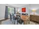 Elegant dining room with hardwood table, black chairs, a decorative painting, and soft natural light at 4 Galaxy Ct, Durham, NC 27705
