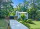 Charming two-story house with a long driveway, lush landscaping, and a carport at 4 Galaxy Ct, Durham, NC 27705