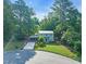 Charming two-story home with inviting curb appeal, manicured lawn, and carport nestled in a serene, wooded neighborhood at 4 Galaxy Ct, Durham, NC 27705