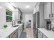 Bright kitchen features modern appliances, gray cabinets, and a view into the office at 4 Galaxy Ct, Durham, NC 27705